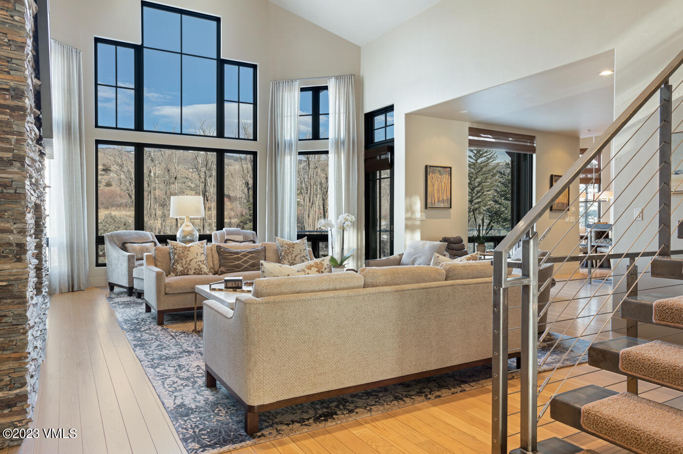 83 Eagle River Road Edwards, CO 81632 - Photo 14 of 64 a living room with furniture and large windows