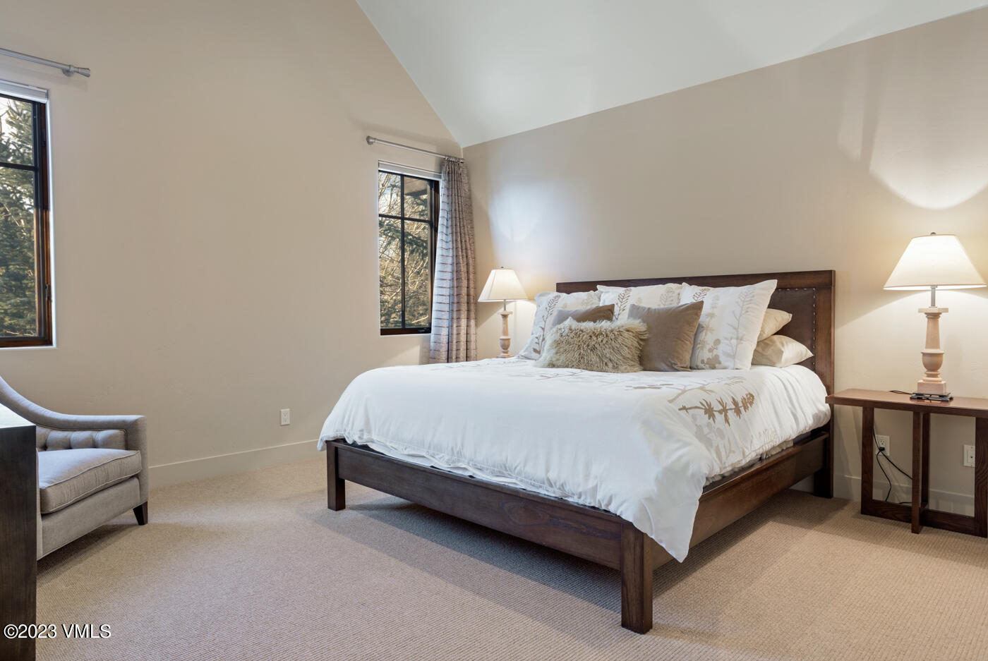 83 Eagle River Road Edwards, CO 81632 - Photo 46 of 64 a large bed sitting in a bedroom next to a lamp