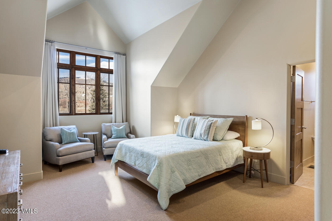 83 Eagle River Road Edwards, CO 81632 - Photo 47 of 64 a bedroom with a bed couch and a window