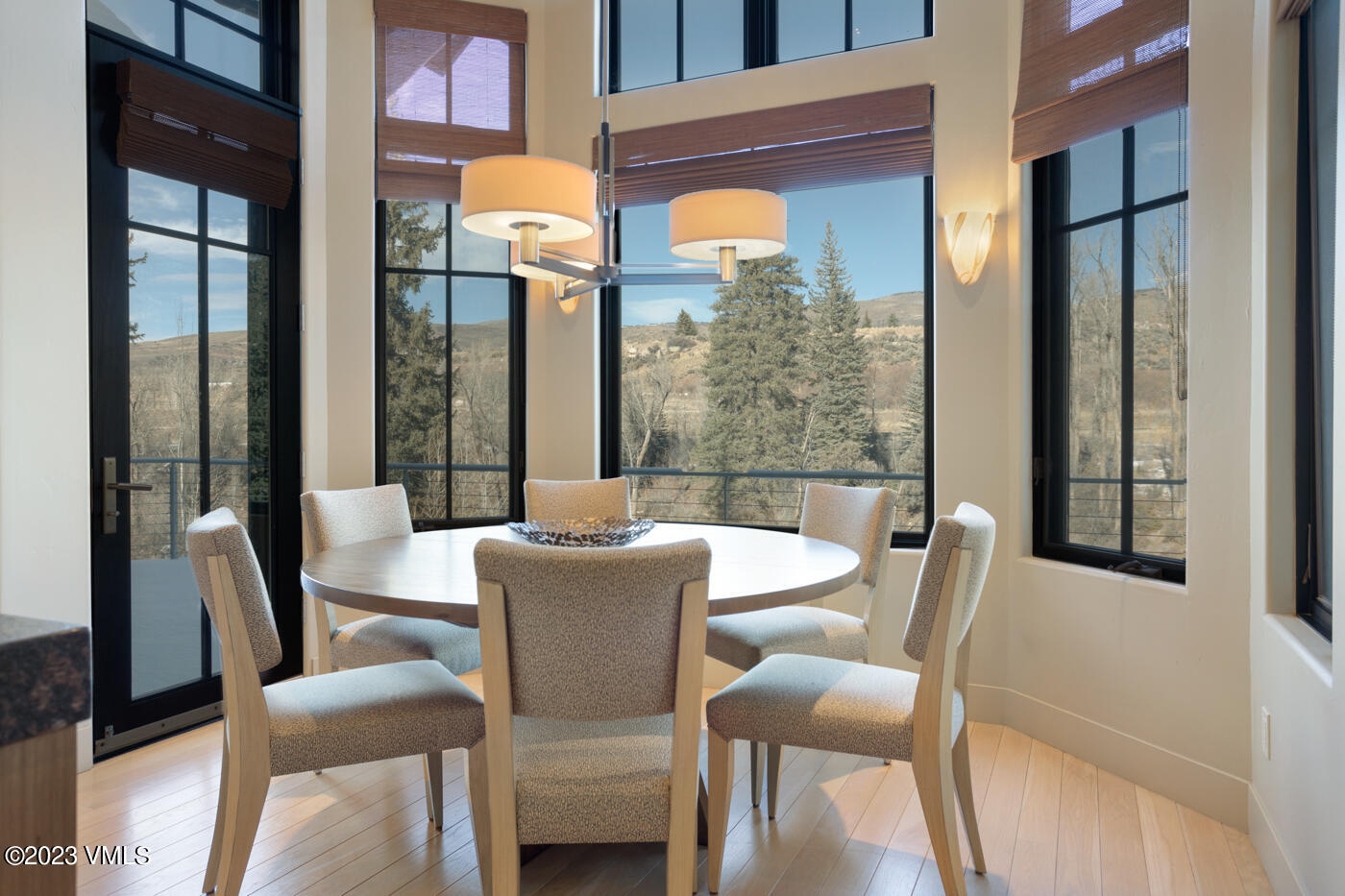 83 Eagle River Road Edwards, CO 81632 - Photo 6 of 64 a view of a dining room with furniture a chandelier and wooden floor