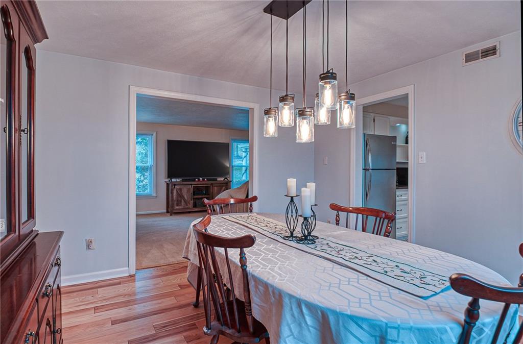 3223 Ridgeway Road Greensburg, PA 15601 - Photo 8 of 25 FORMAL DINING ROOM: Newer light fixture, beautiful hardwood flooring & lots of natural light.