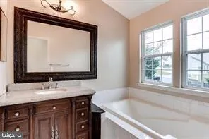 a bathroom with a sink vanity and a mirror