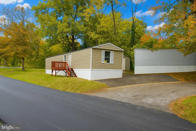 a view of a house with pool and a yard