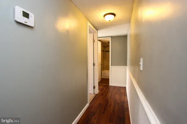 a view of a hallway with wooden floor