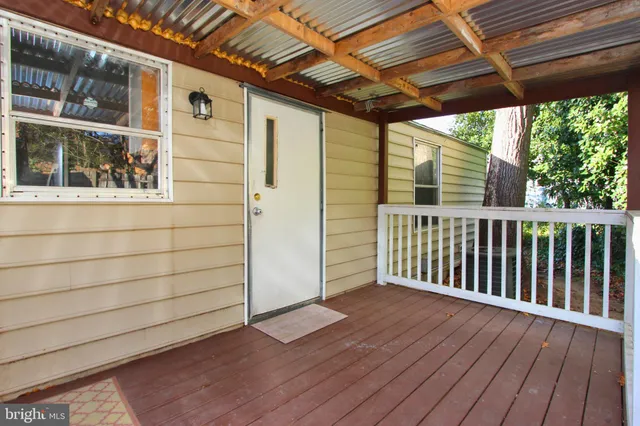 a view of a porch with wooden floor and outdoor space