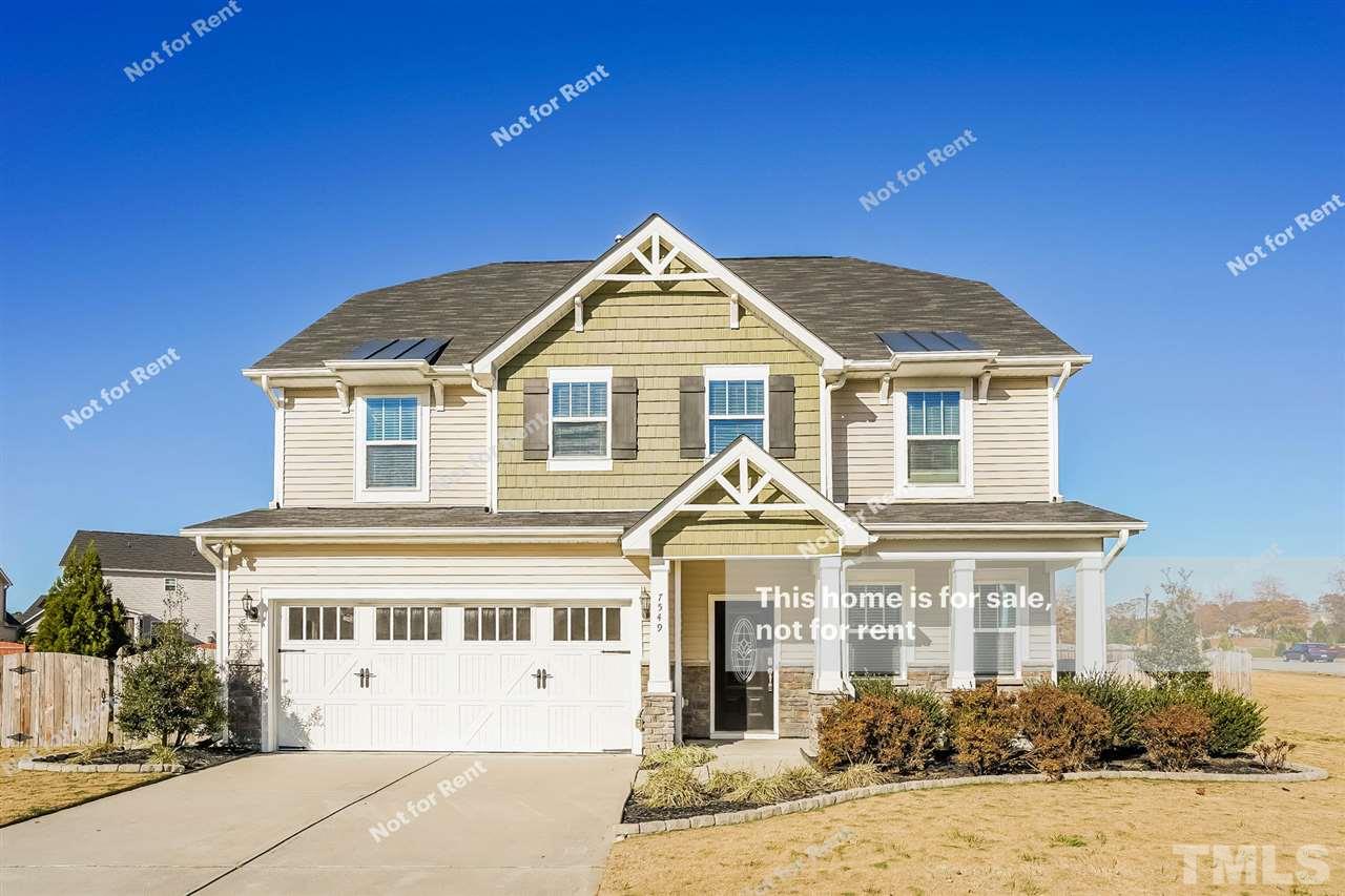 7549 Channery Way Raleigh, NC 27616 - Photo 1 of 27 a front view of a house with a yard