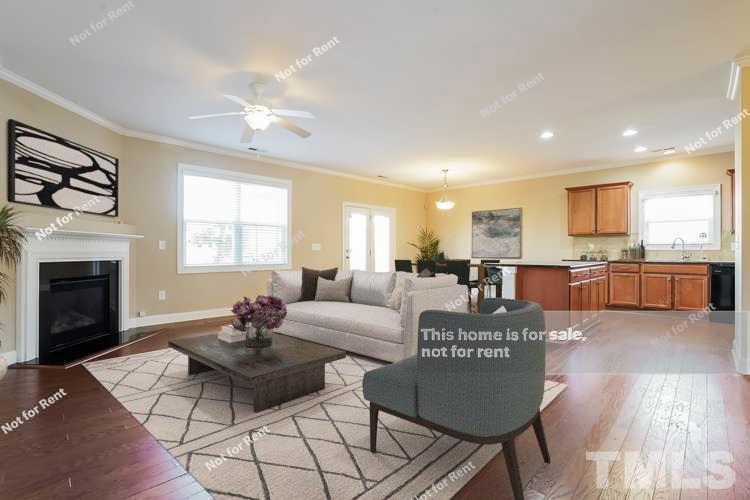 7549 Channery Way Raleigh, NC 27616 - Photo 2 of 27 a living room with furniture and a fireplace