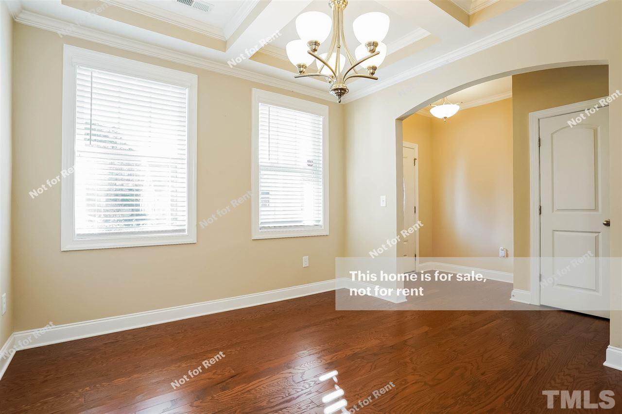 7549 Channery Way Raleigh, NC 27616 - Photo 11 of 27 a view of an empty room with wooden floor and a window