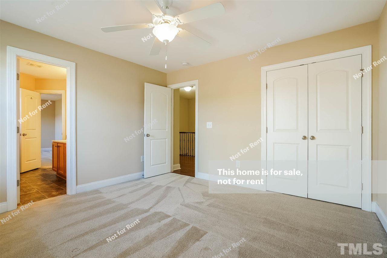 7549 Channery Way Raleigh, NC 27616 - Photo 22 of 27 a view of a big room with closet and a chandelier fan