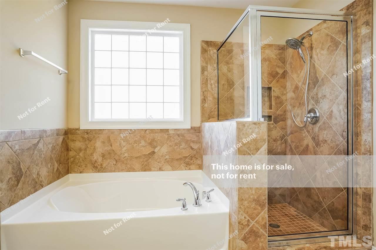 7549 Channery Way Raleigh, NC 27616 - Photo 24 of 27 a bathroom with a bathtub and a shower