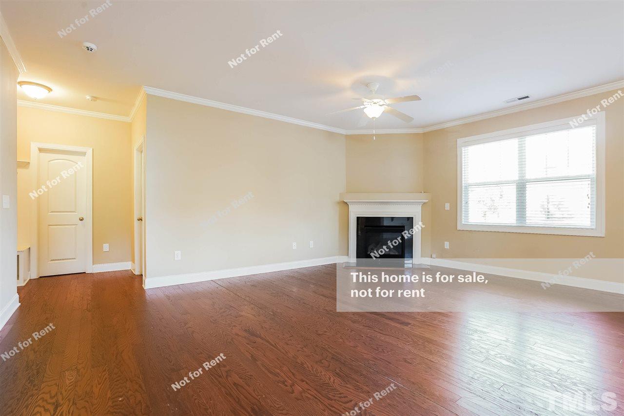 7549 Channery Way Raleigh, NC 27616 - Photo 5 of 27 a view of an empty room with window and fireplace
