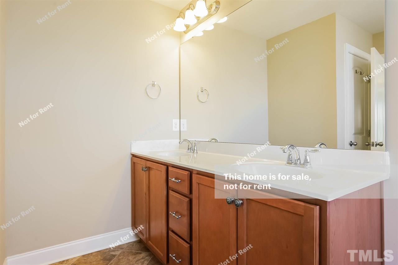 7549 Channery Way Raleigh, NC 27616 - Photo 6 of 27 a bathroom with a granite countertop sink and a mirror