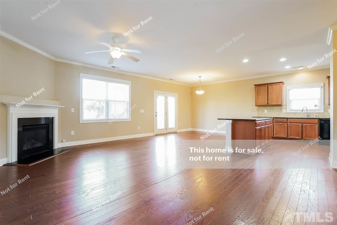 7549 Channery Way Raleigh, NC 27616 - Photo 9 of 27 a view of an empty room with wooden floor and a window