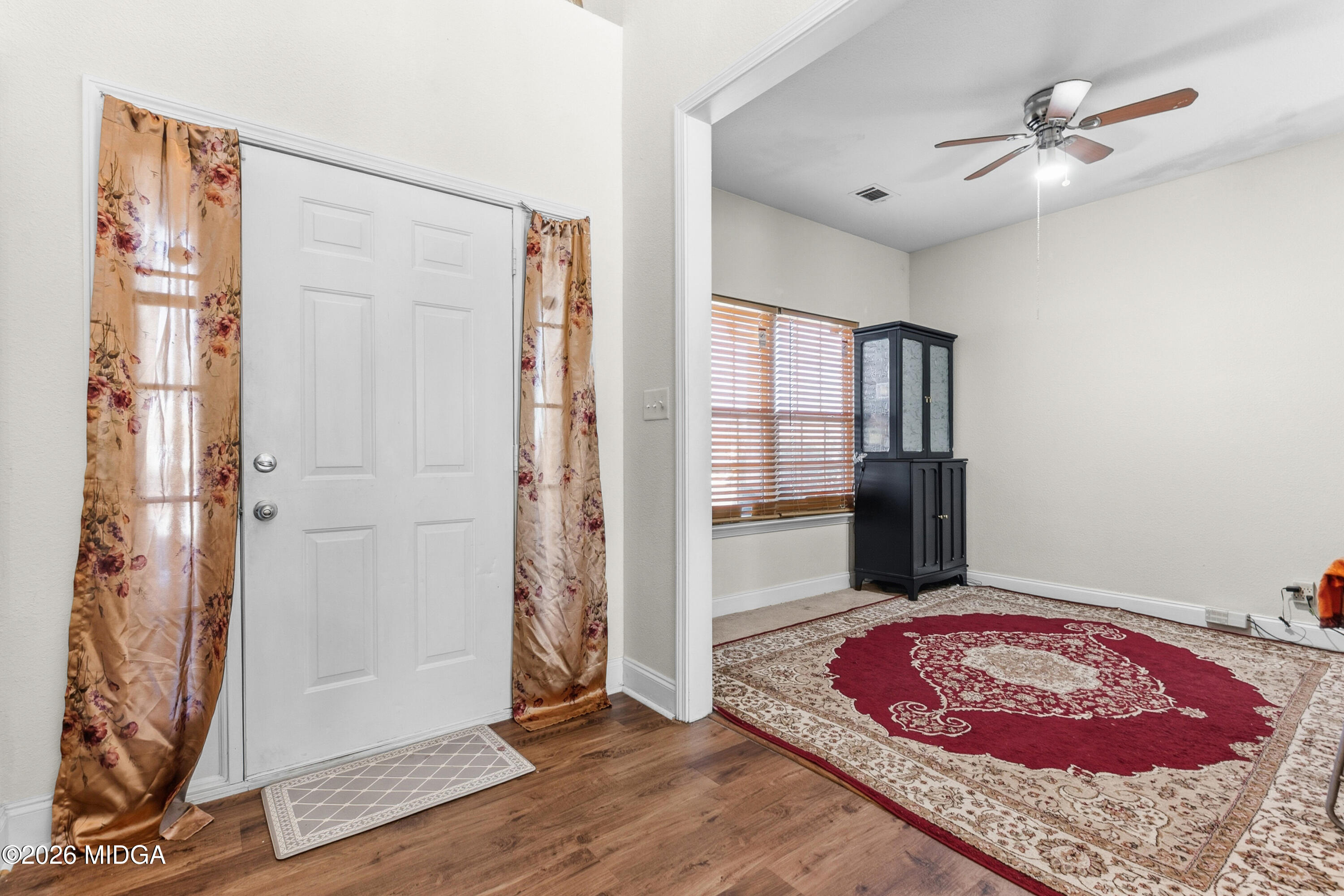 106 Shiloh Court Macon, GA 31206 - Photo 3 of 46 a very nice looking empty room with a fireplace and a chandelier fan