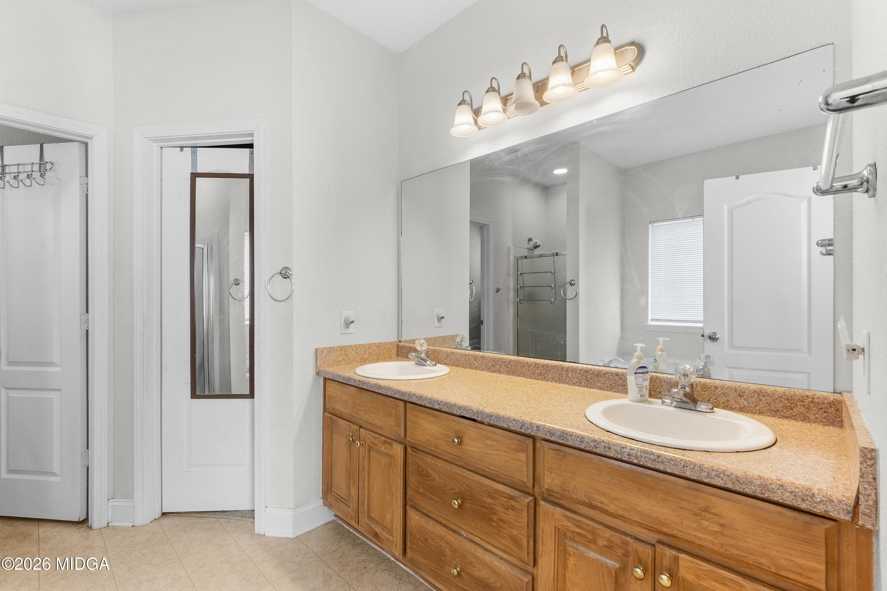 106 Shiloh Court Macon, GA 31206 - Photo 36 of 46 a bathroom with a granite countertop sink a large mirror and a shower