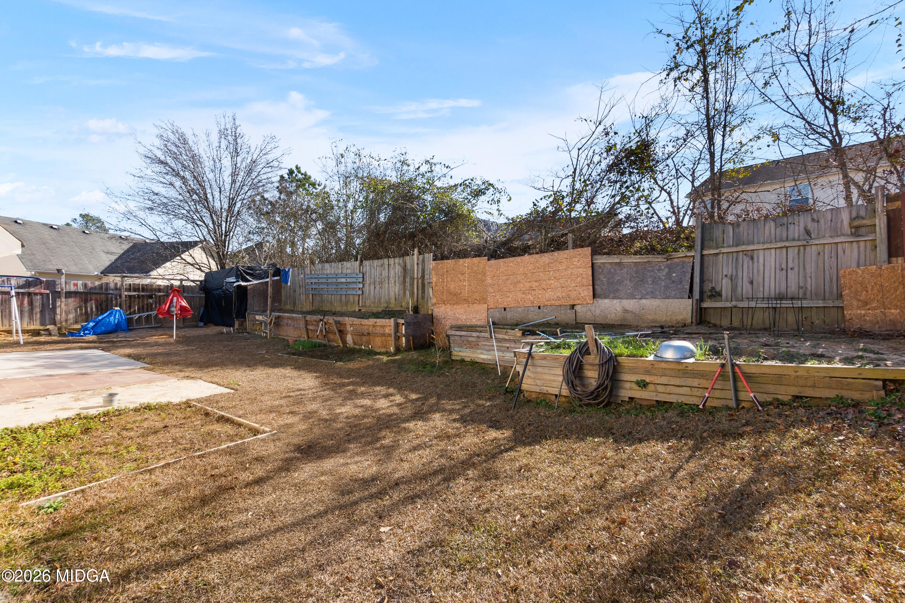 106 Shiloh Court Macon, GA 31206 - Photo 41 of 46 a view of a backyard with large trees and wooden fence