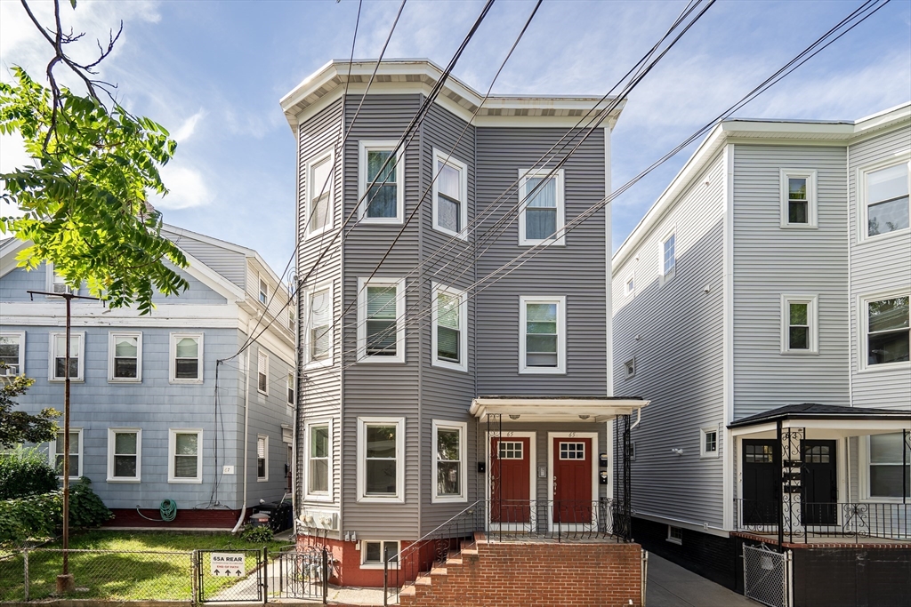 a front view of a building with garden