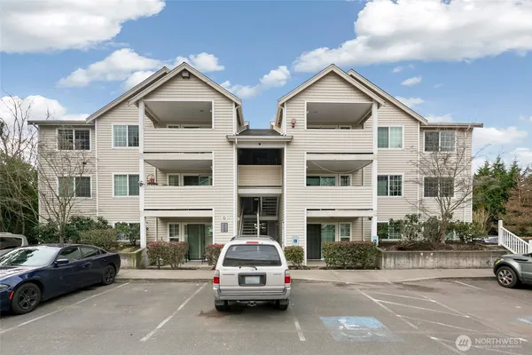 a car parked in front of a white building