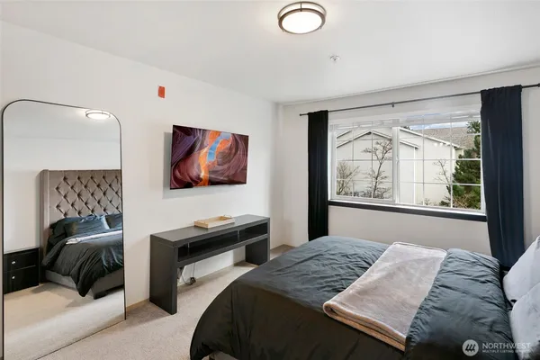 a bedroom with a bed and a flat screen tv