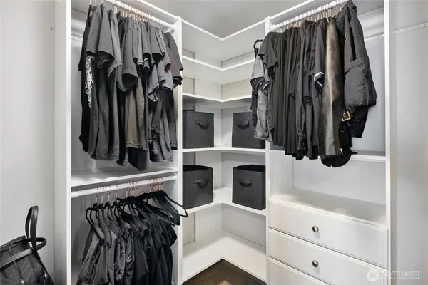 a view of walk in closet with clothes and shoes
