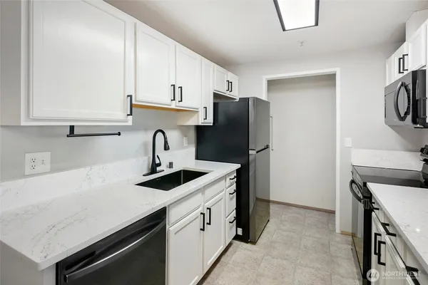 a kitchen with a sink and a refrigerator