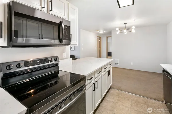 a kitchen with a stove and a microwave