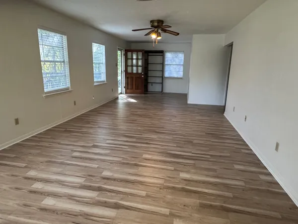 wooden floor in an empty room with a window