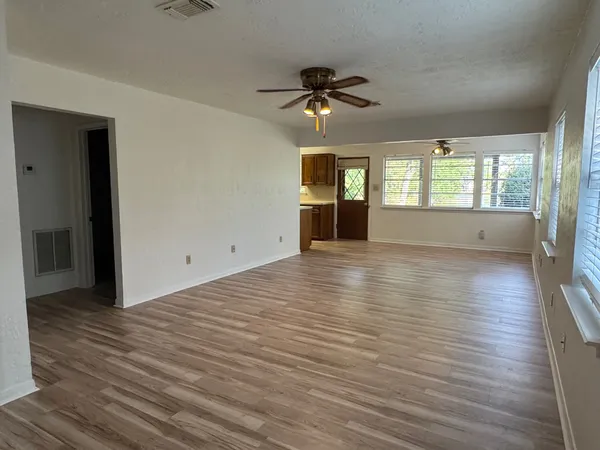 wooden floor in an empty room with a window