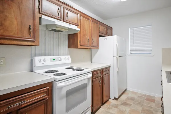 a kitchen with a stove and a refrigerator