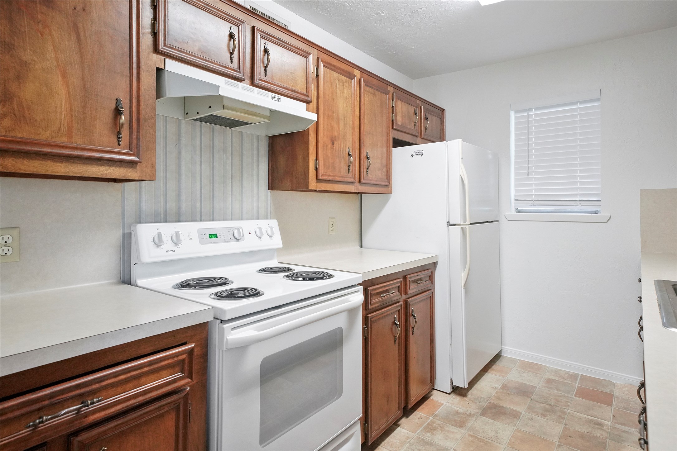 18121 Atkinson Lane Conroe, TX 77384 - Photo 17 of 29 a kitchen with a stove and a refrigerator