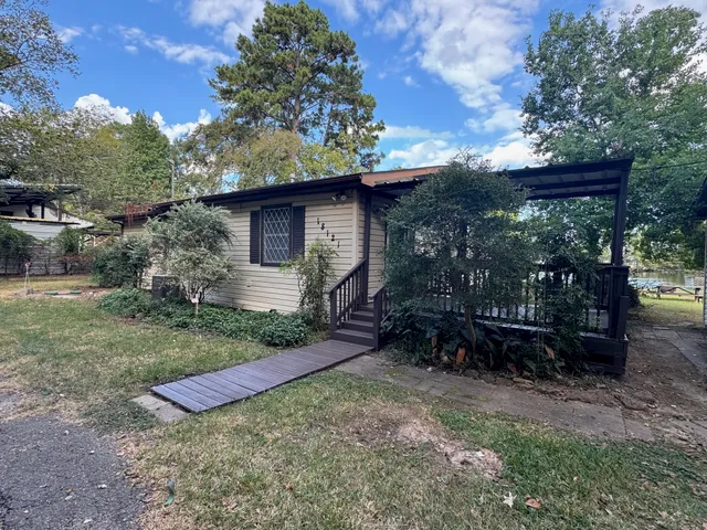 a view of a backyard with plants and a patio