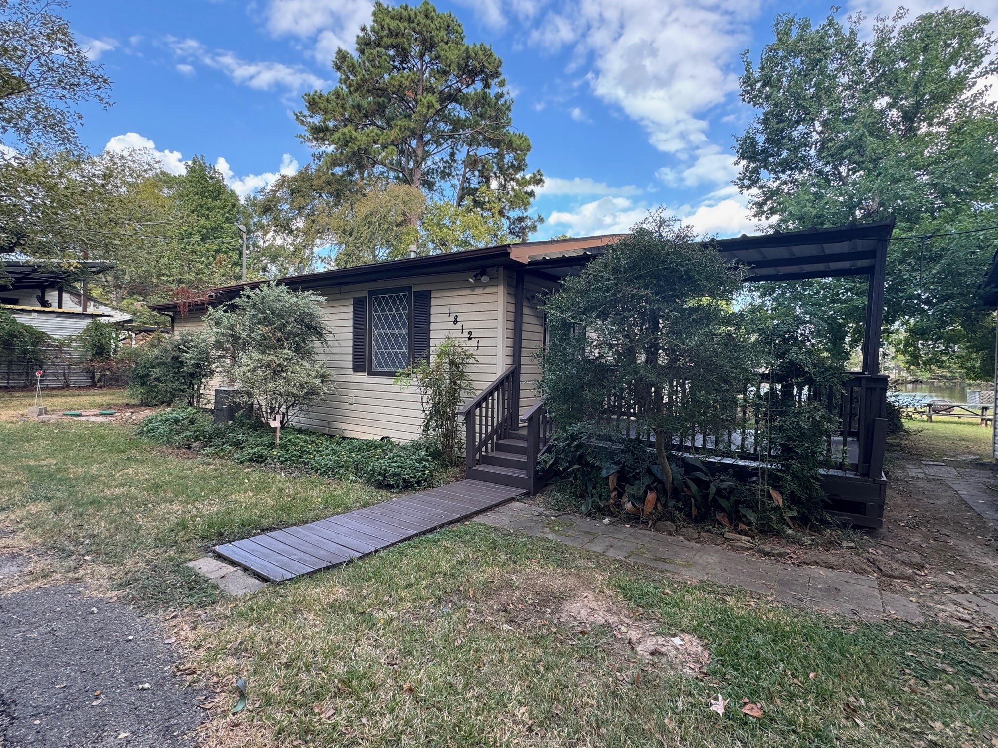 18121 Atkinson Lane Conroe, TX 77384 - Photo 26 of 29 a view of a backyard with plants and a patio
