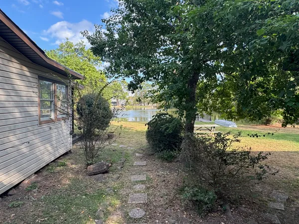 a view of a yard with wooden fence