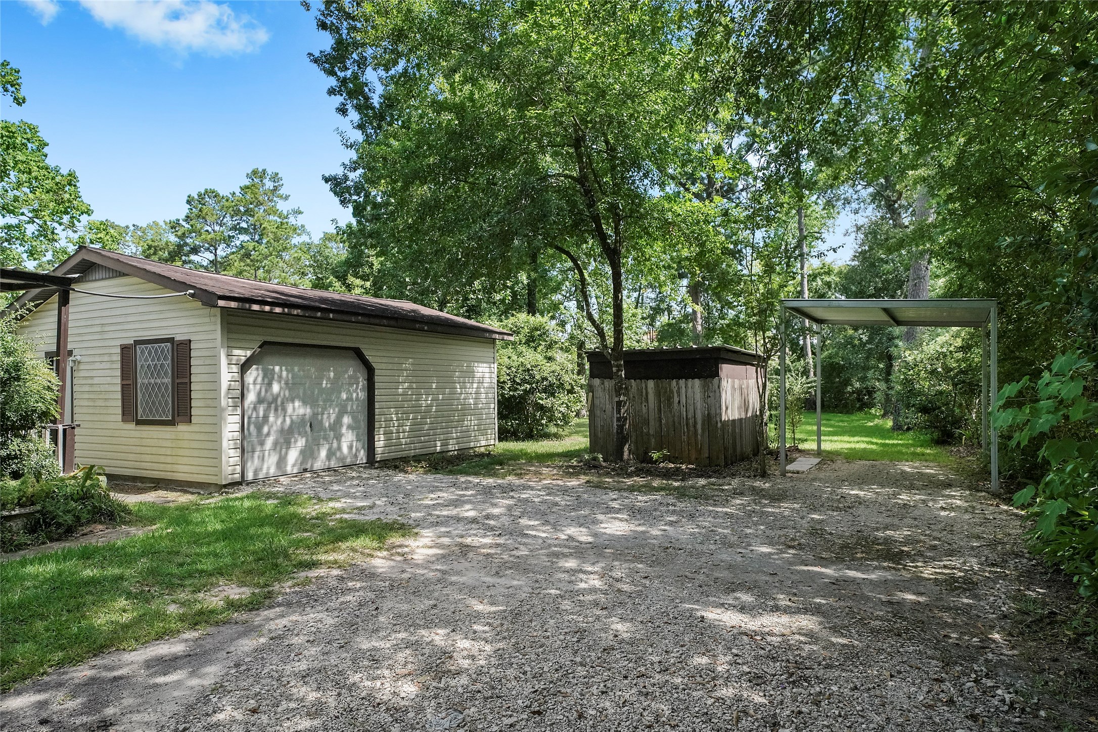 18121 Atkinson Lane Conroe, TX 77384 - Photo 3 of 29 a view of a house with large trees and a large tree