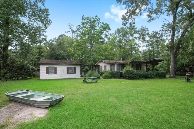 a view of a backyard with table and chairs and a yard