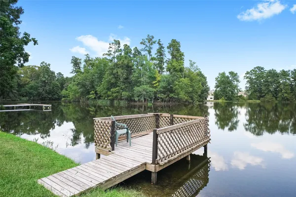 a view of a wooden deck with lake view