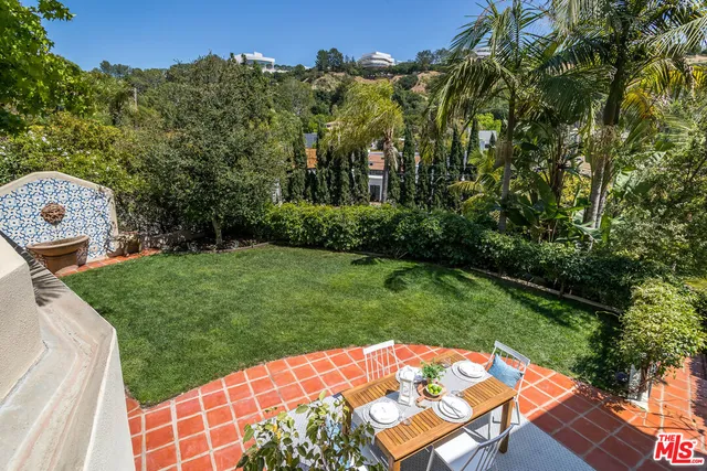 a view of a dining room with furniture wooden floor and a potted plant