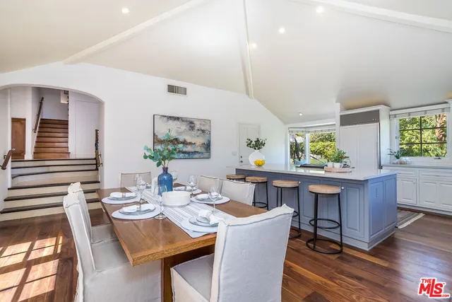 a bedroom with a large bed and a tv