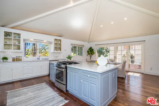 a spacious bathroom with a granite countertop sink and a mirror