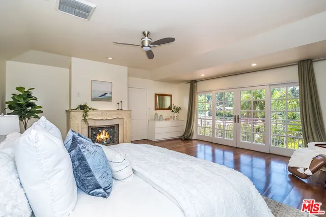 a bedroom with a large bed and a window