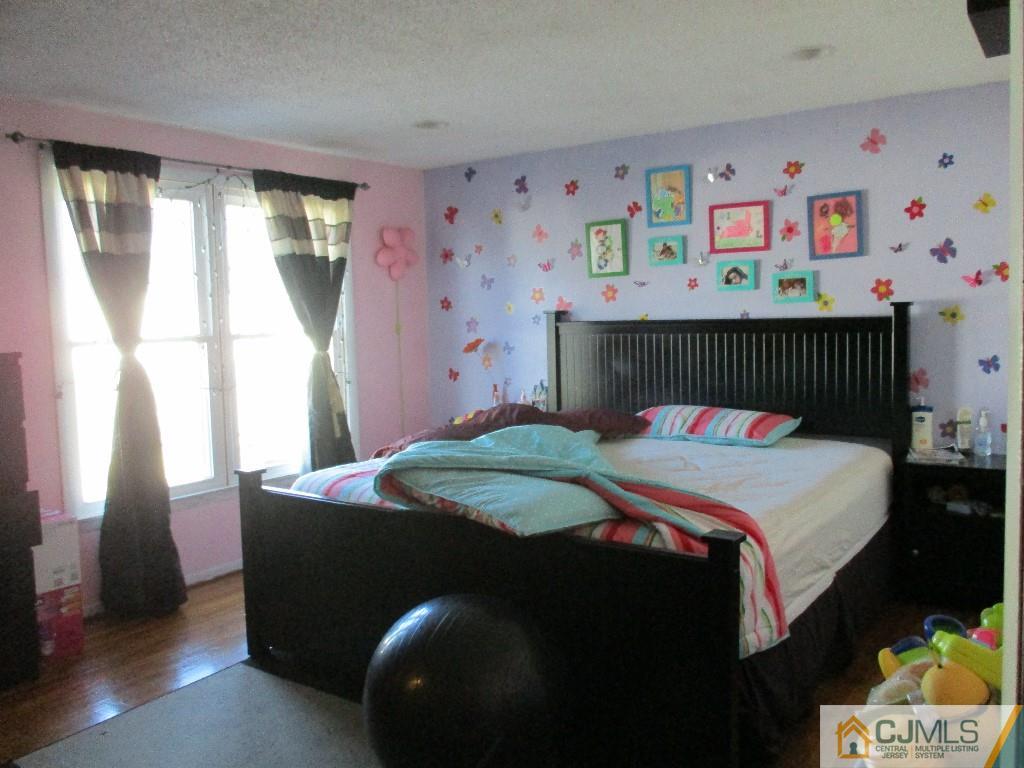 4604 Hana Road Edison, NJ 08817 - Photo 8 of 11 a bedroom with a bed and a window
