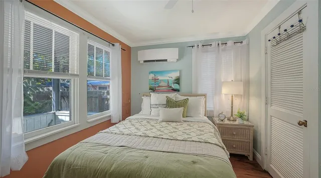 a bedroom with a bed and a window