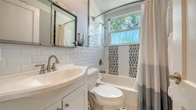 a bedroom with furniture and a large window