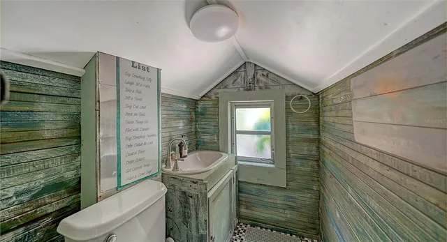 an aerial view of a house with a yard and garden