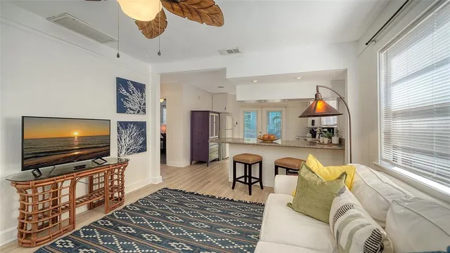 a kitchen with a sink and chairs