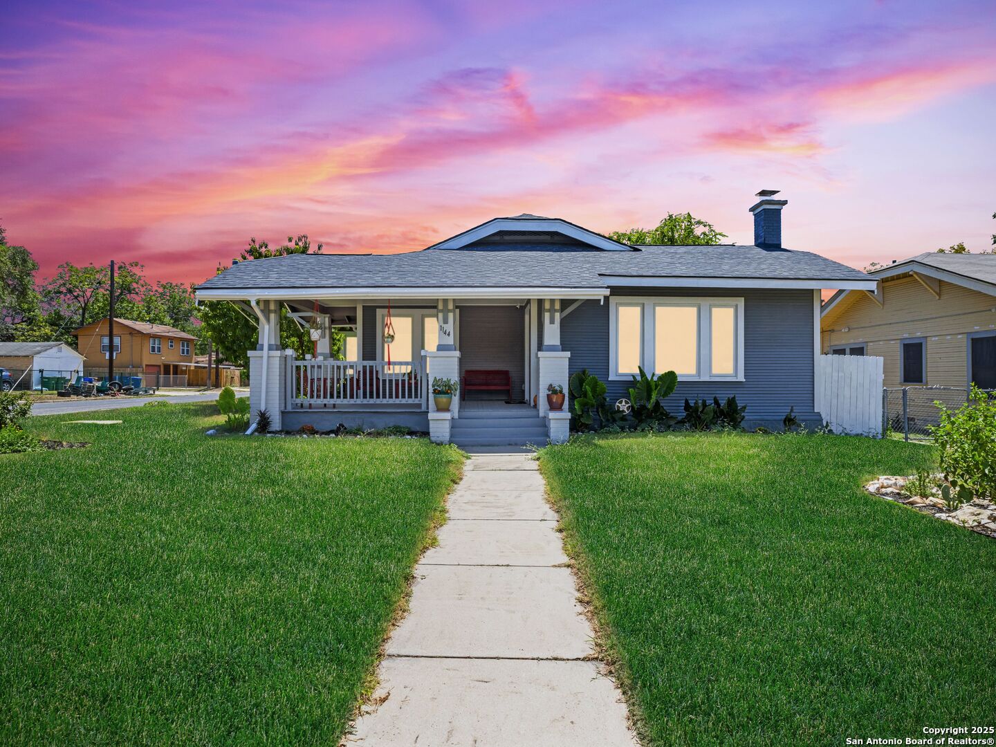 a front view of a house with a garden and yard