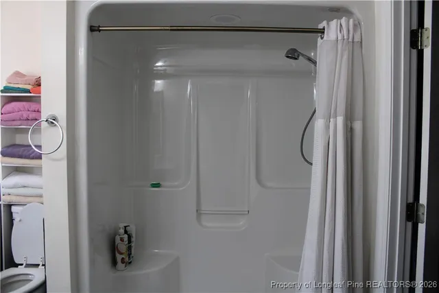 a bathroom with a glass shower door