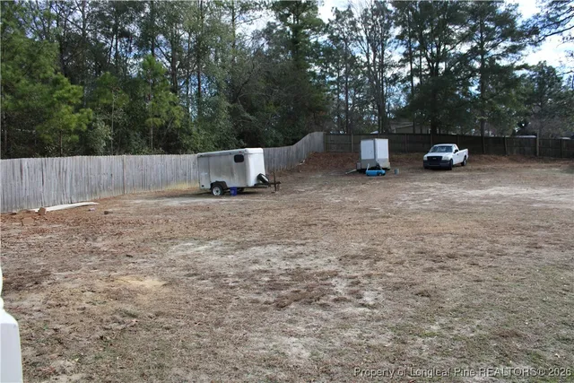 a backyard of a house with cars parked