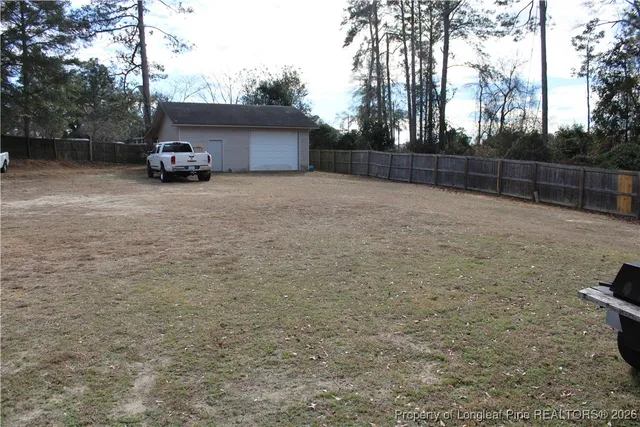 a view of backyard with parked car