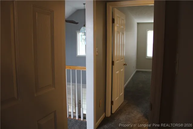 a view of a hallway with wooden shelves